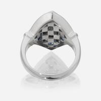 An eighteen karat white gold, diamond, and sapphire ring