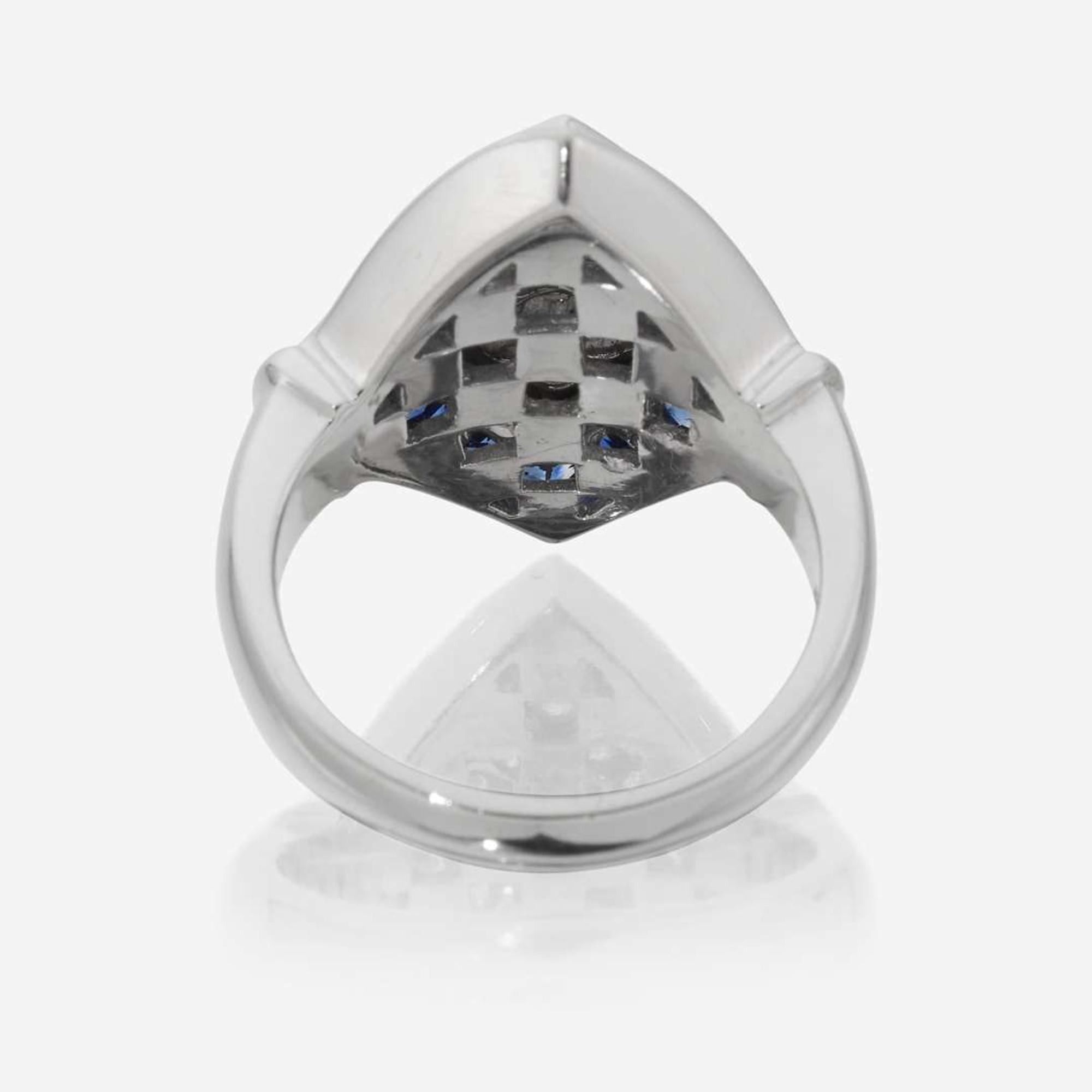 An eighteen karat white gold, diamond, and sapphire ring