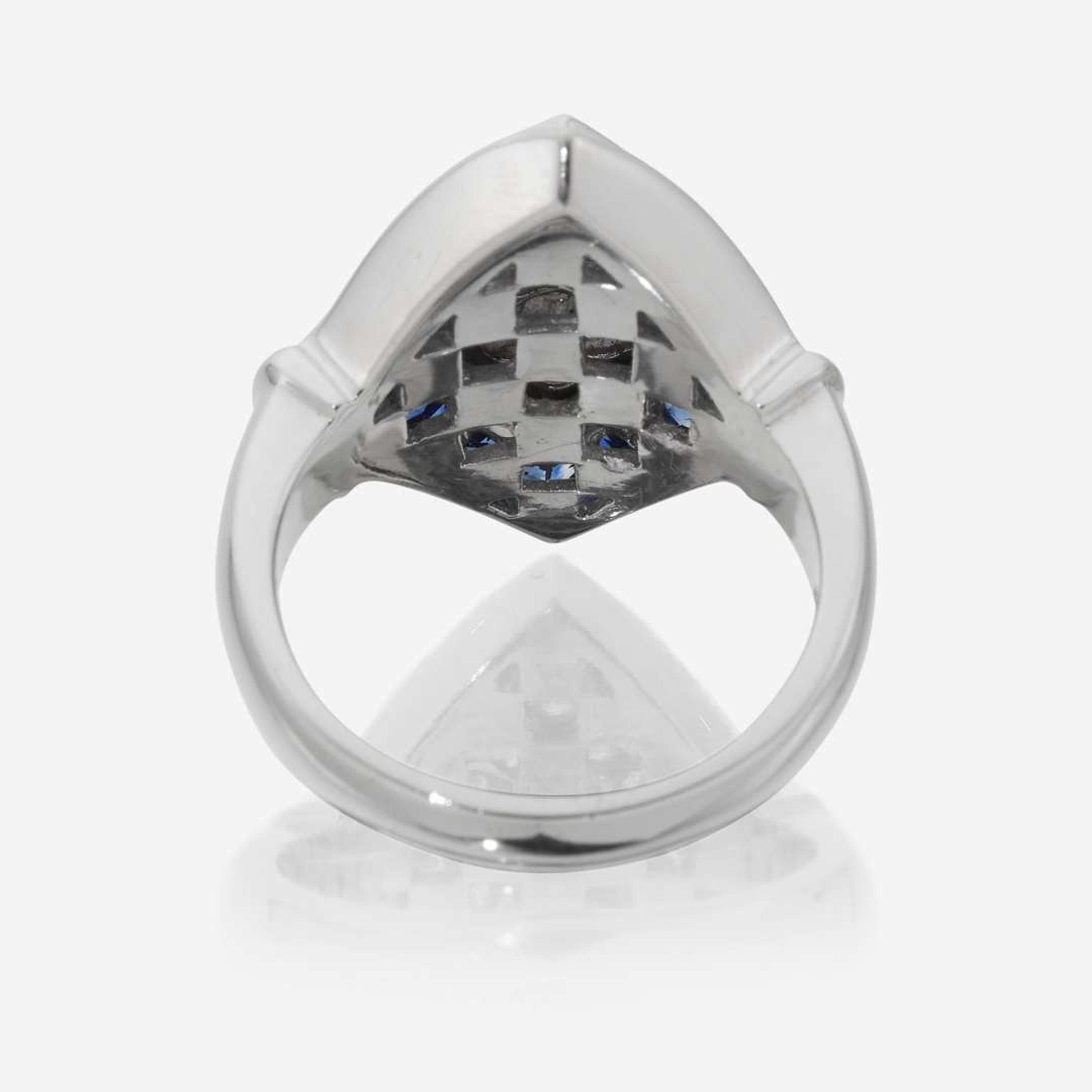 An eighteen karat white gold, diamond, and sapphire ring