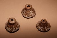 A Group of Six Quimbaya Terracotta Spindle Whorls