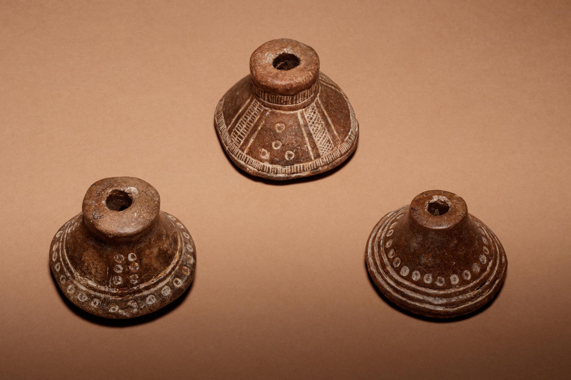 A Group of Six Quimbaya Terracotta Spindle Whorls