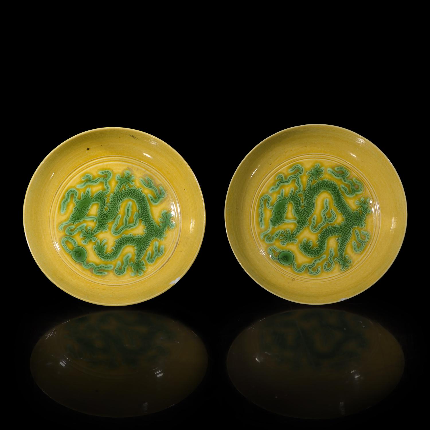 A Pair of Chinese Yellow Ground Green Enameled Porcelain 'Dragon' Dishes 黃地綠彩刻龍紋盤一對