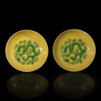 A Pair of Chinese Yellow Ground Green Enameled Porcelain 'Dragon' Dishes 黃地綠彩刻龍紋盤一對