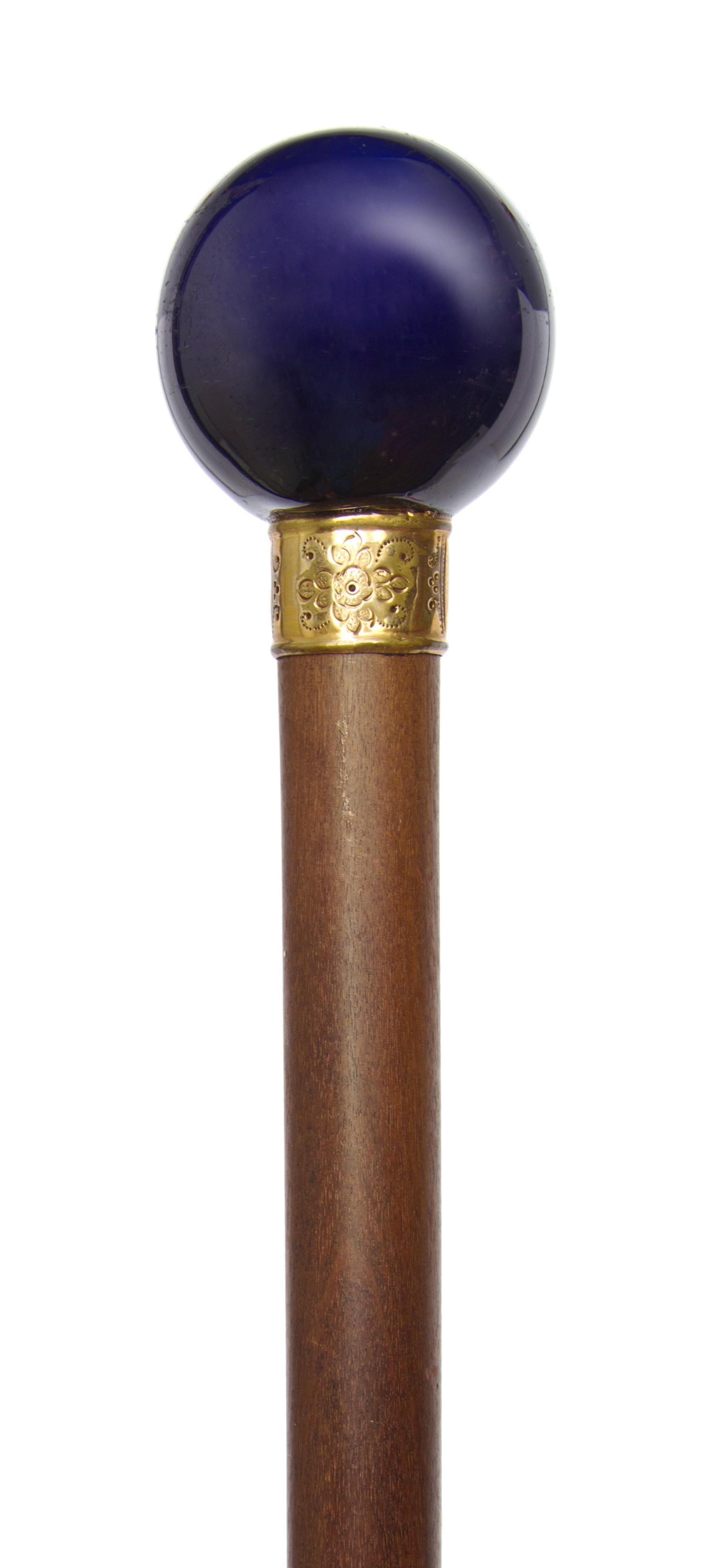 A French Porcelain Handled Walking Stick, Diameter of handle 1 3/4 x length overall 34 5/8 inches.