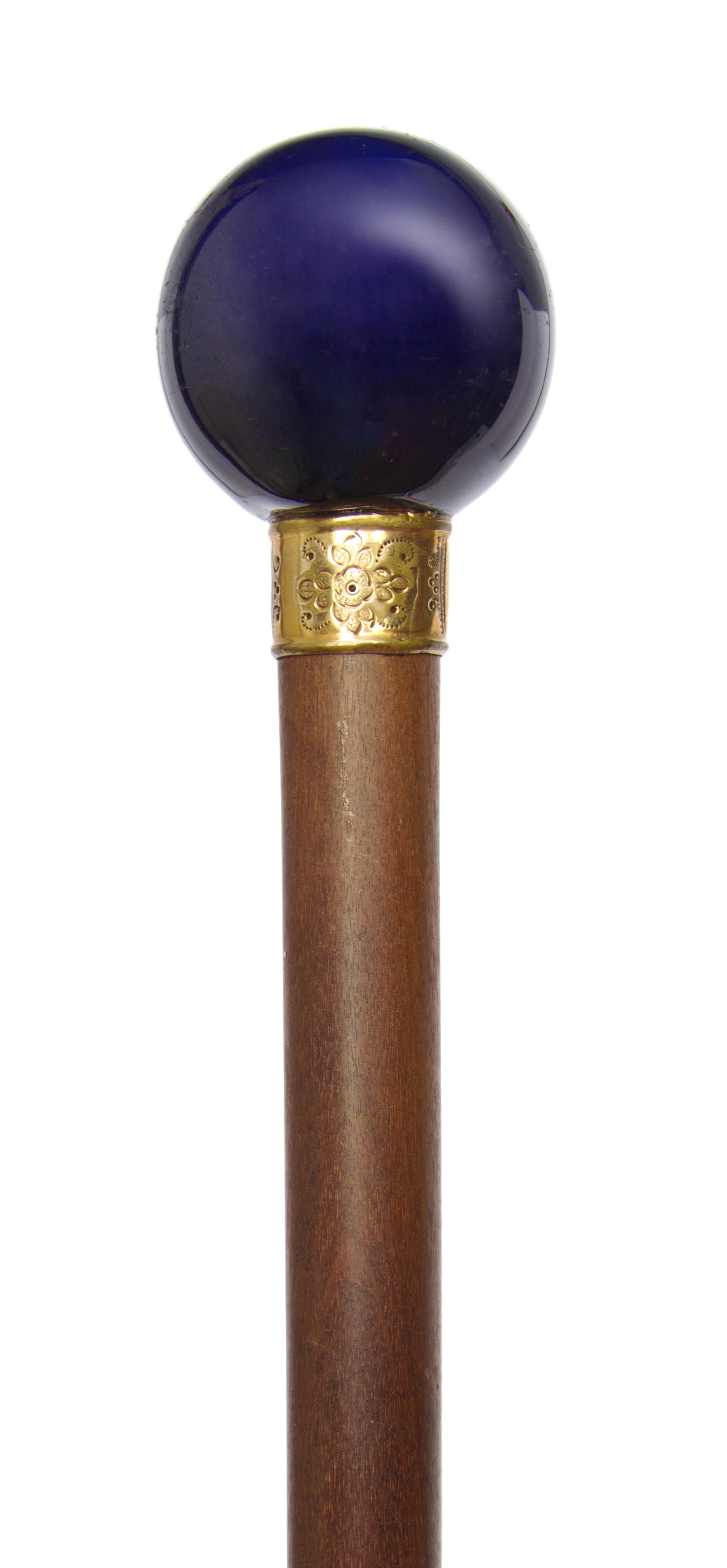 A French Porcelain Handled Walking Stick, Diameter of handle 1 3/4 x length overall 34 5/8 inches.
