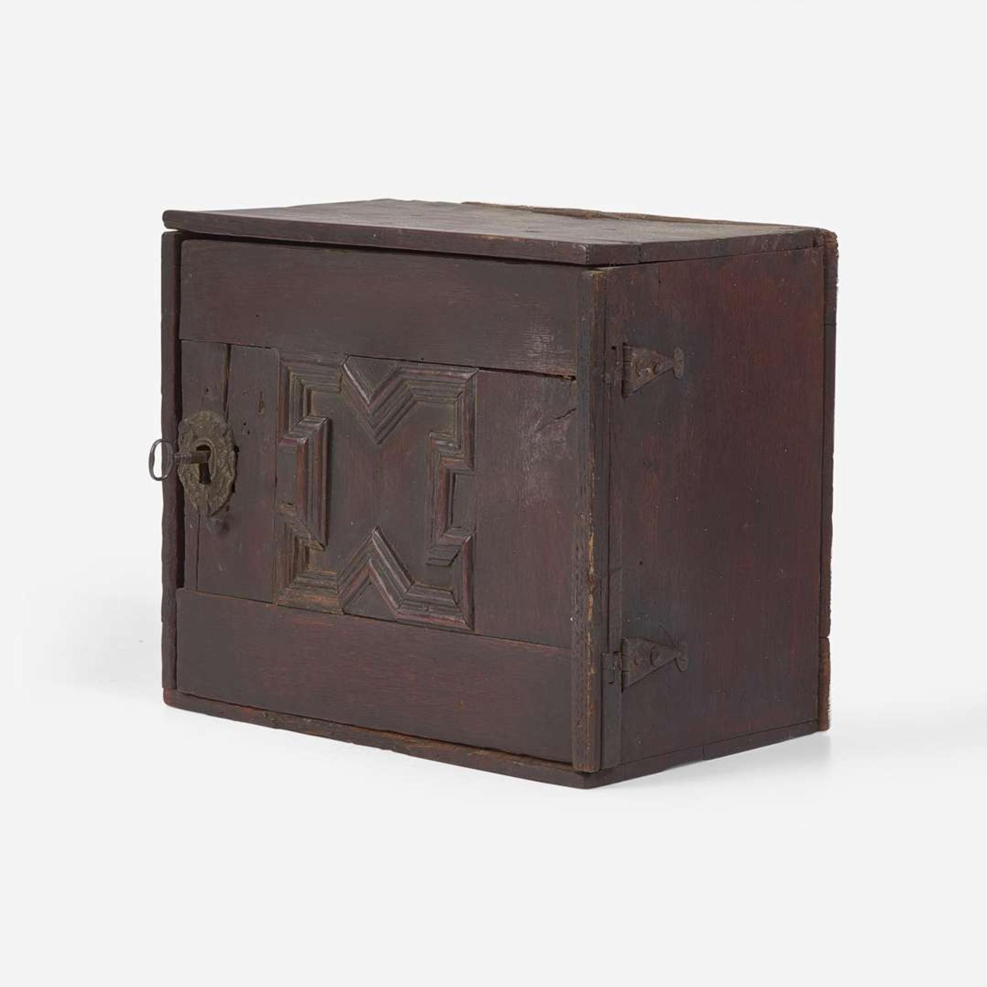 A Charles I carved oak wall-hanging spice cupboard circa 1650
