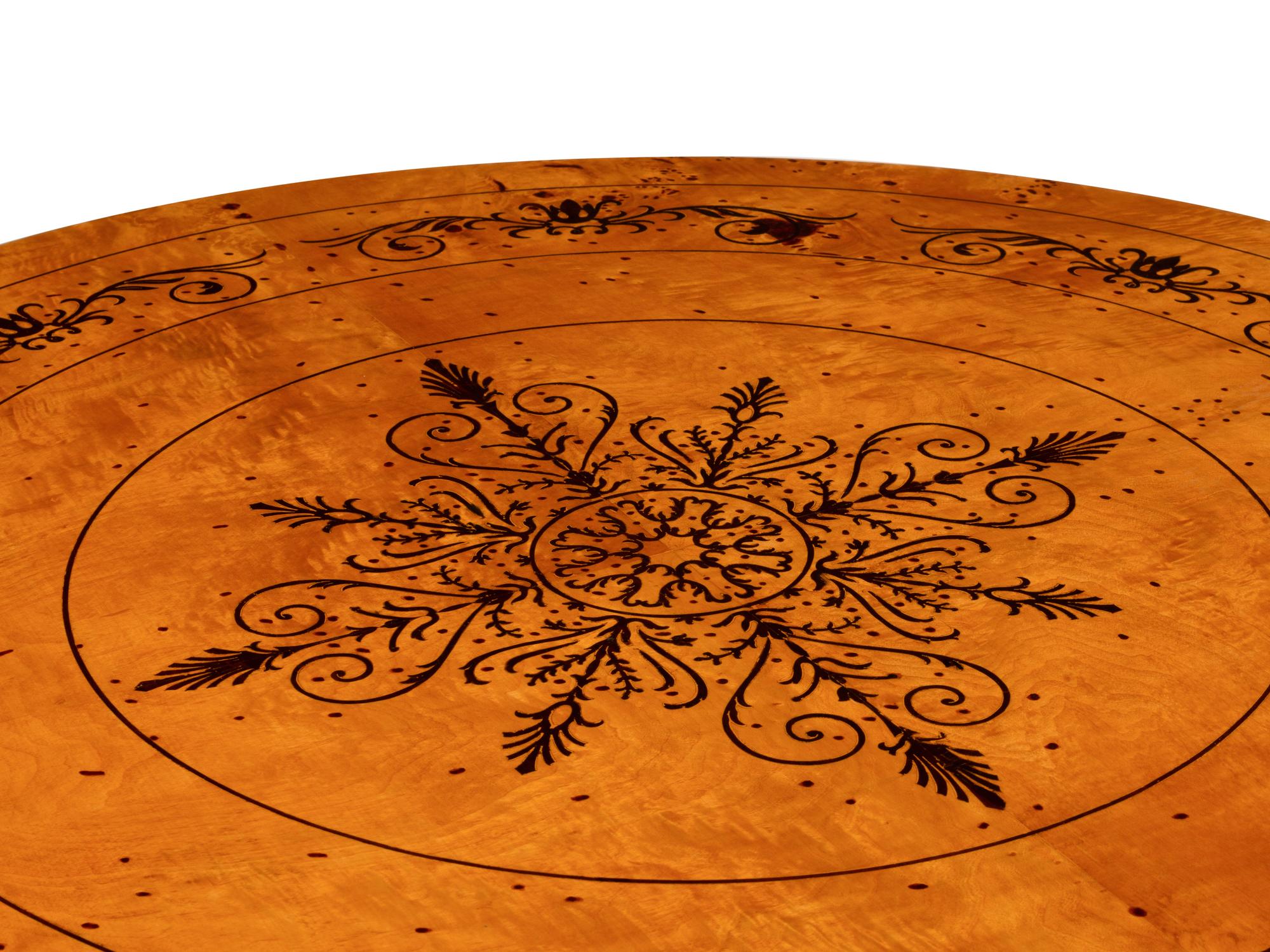 A Charles X Style Burlwood and Marquetry Center Table