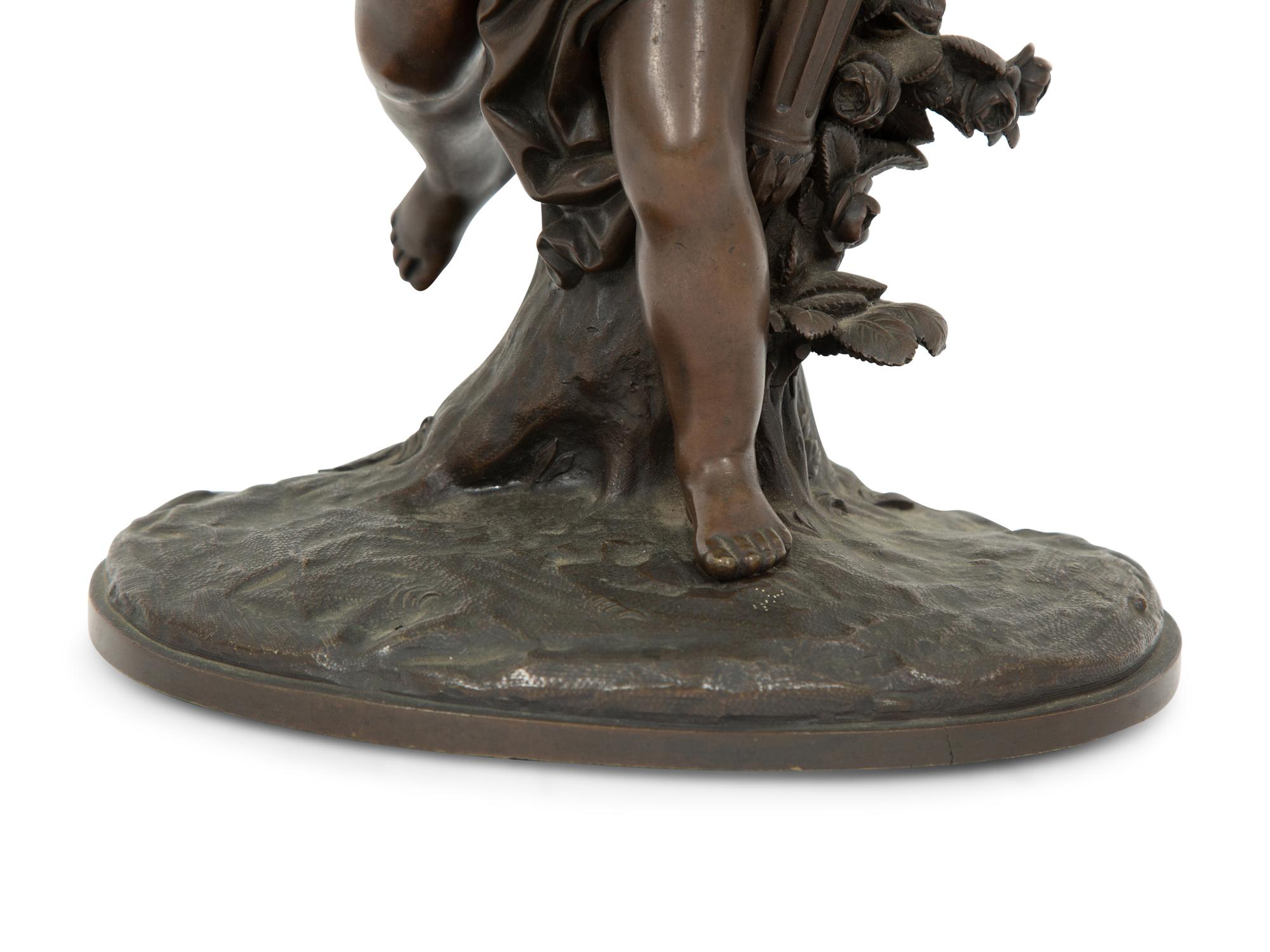 A French Bronze Figure of Eros on a Wood Base