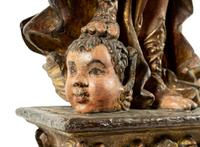 A Pair of Continental Carved, Painted and Parcel Gilt Figural Pricket Sticks