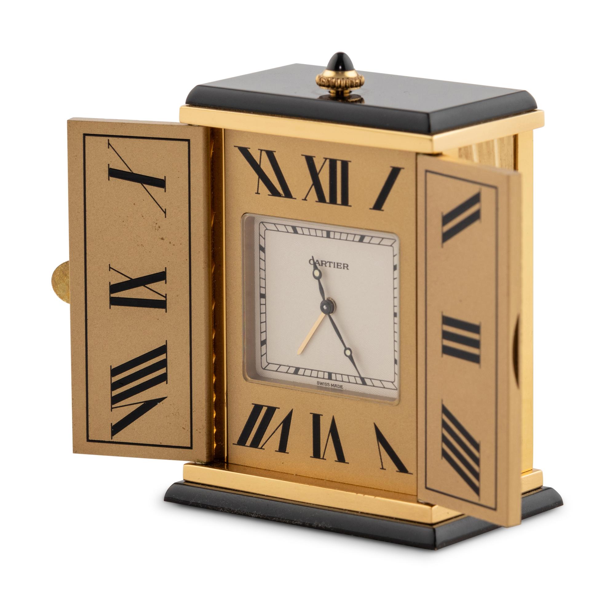 A Cartier Engraved Brass and Onyx Travel Clock