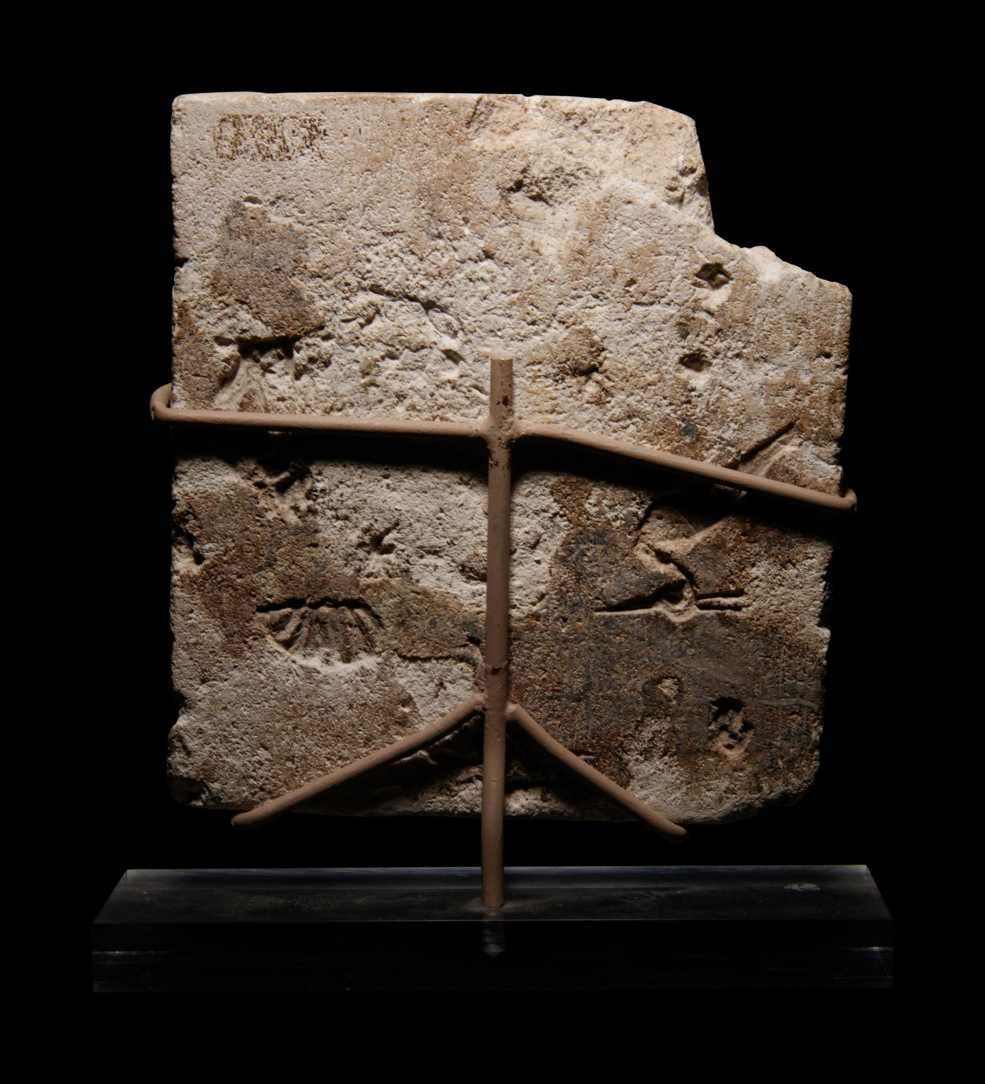 An Egyptian Limestone Sculptor's Model or Votive Relief