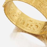 A gold bangle bracelet