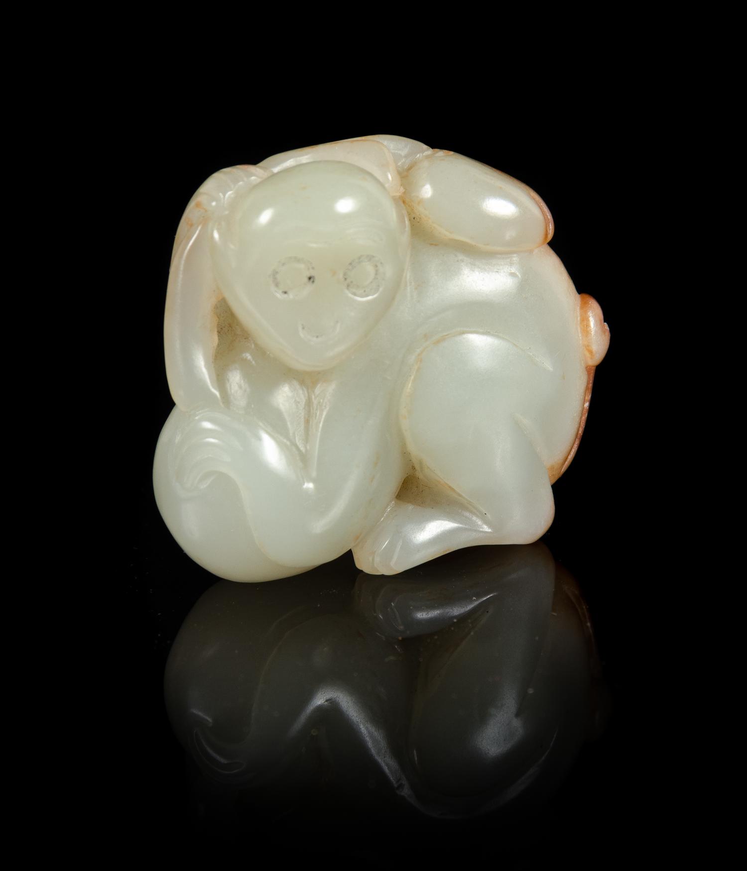 A Celadon and Russet Jade Figure of a Monkey