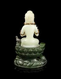 A Pale Celadon and Spinach Jade Figure of Guanyin