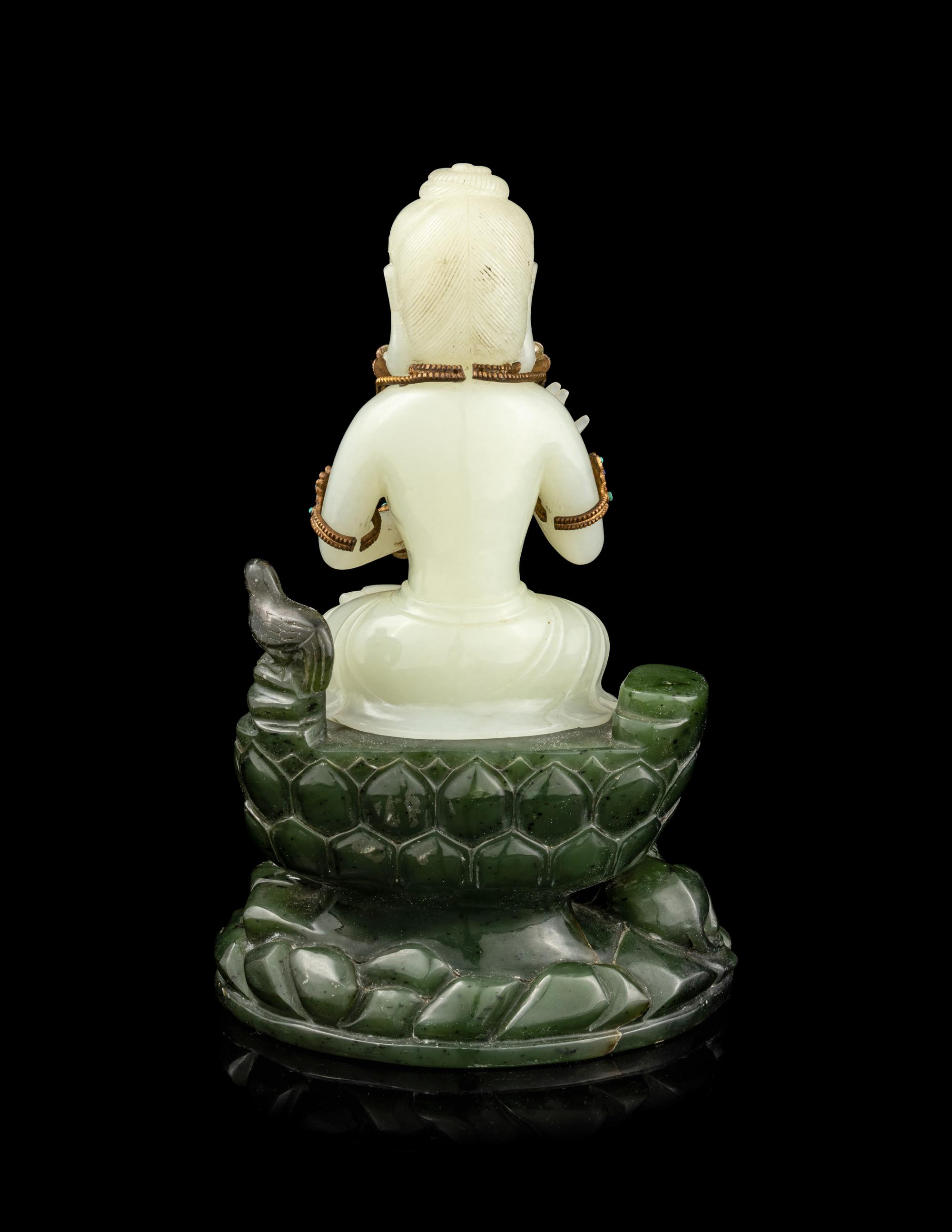 A Pale Celadon and Spinach Jade Figure of Guanyin