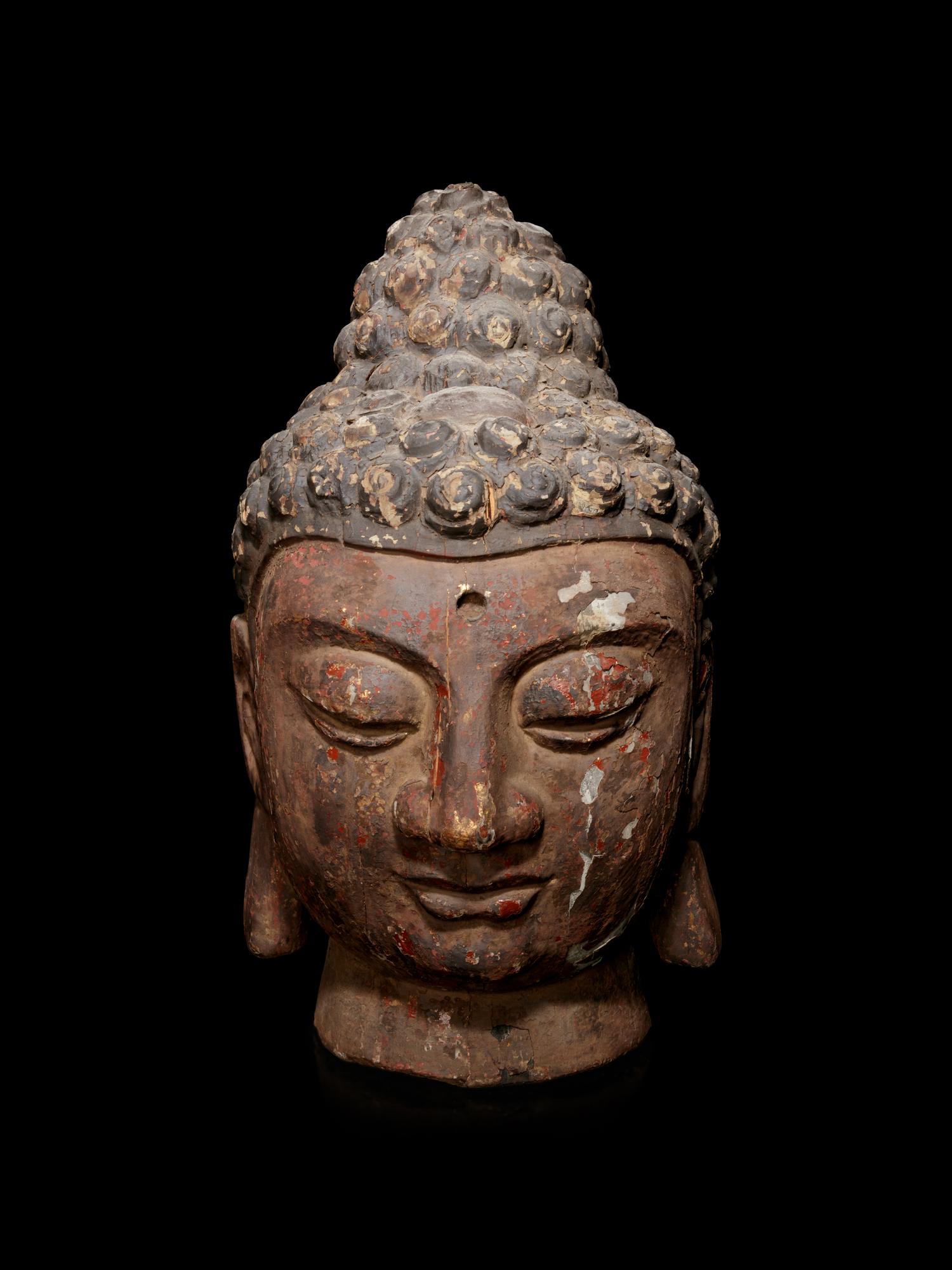 A Carved Wood Head of Buddha