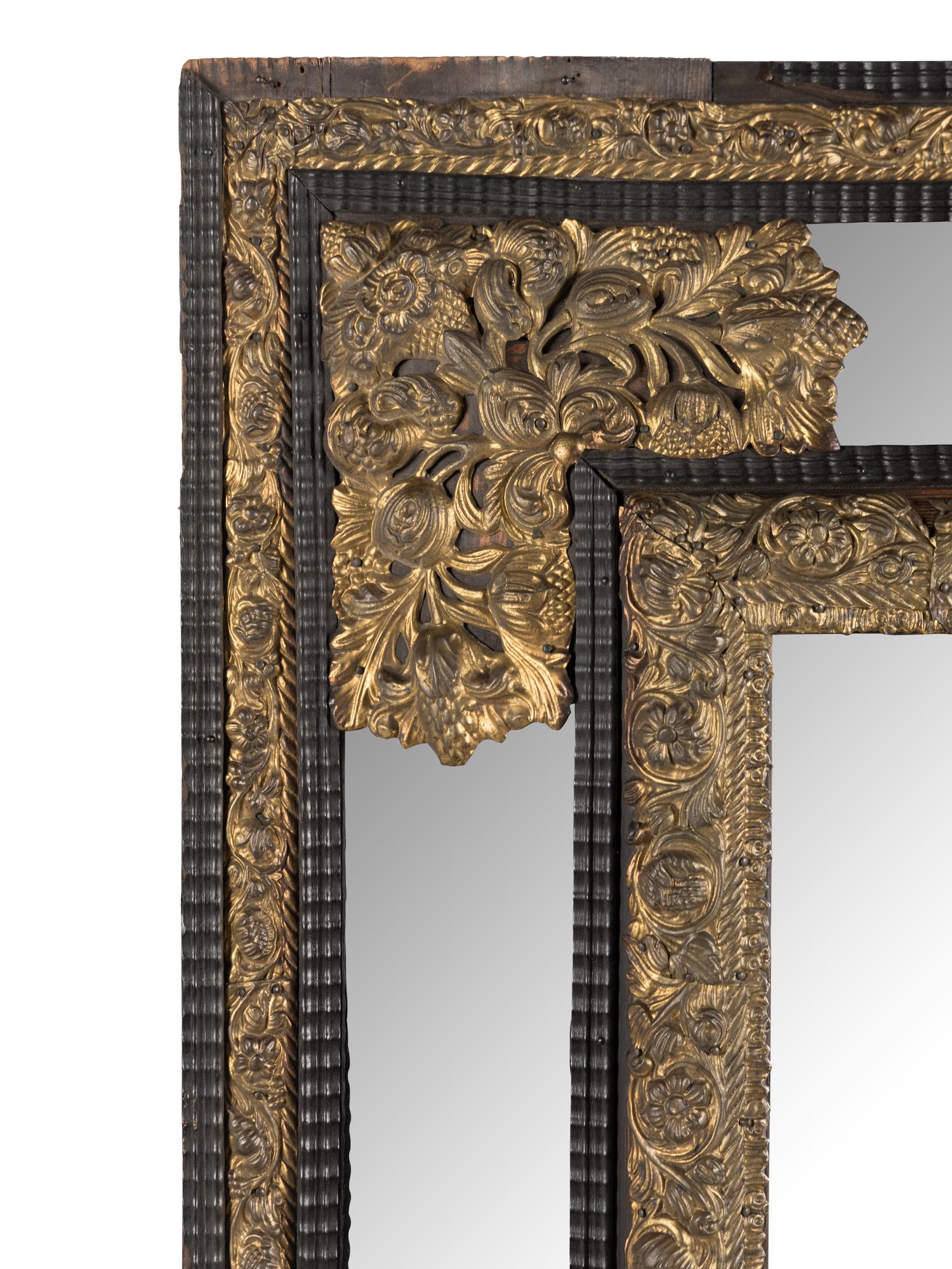 A Dutch Pressed Brass and Part Ebonized Mirror