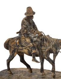 A Russian Gilt Bronze Figural Group of a Man on Horseback