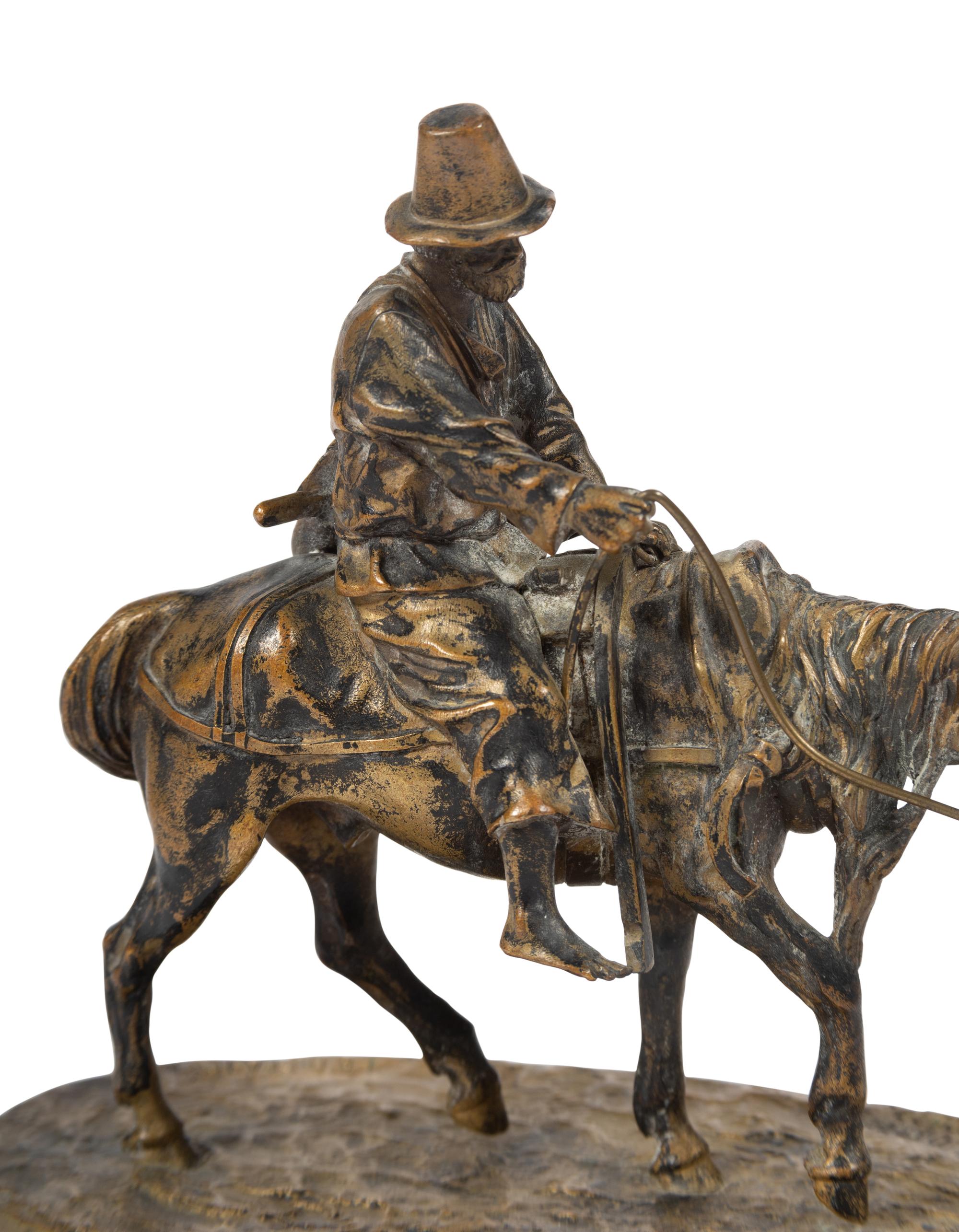 A Russian Gilt Bronze Figural Group of a Man on Horseback