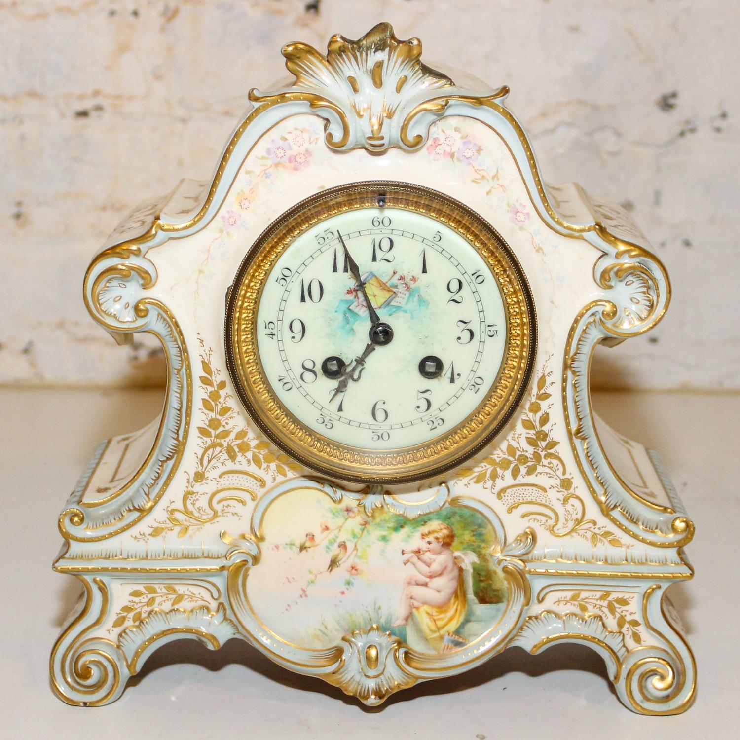 A Continental Porcelain Mantle Clock. Height 11 inches.