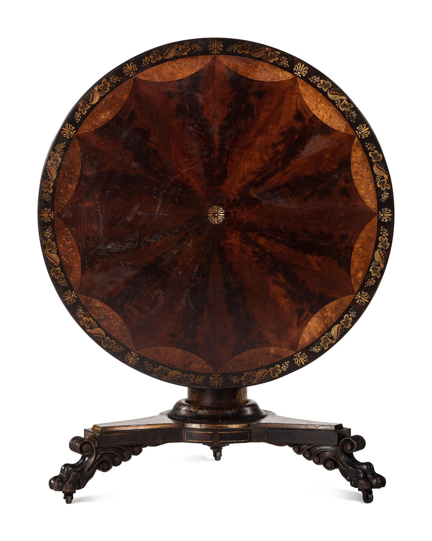 A Classical Parcel Gilt, Stencil Decorated, Carved and Inlaid Mahogany Tilt-Top Claw-Foot Breakfast Table