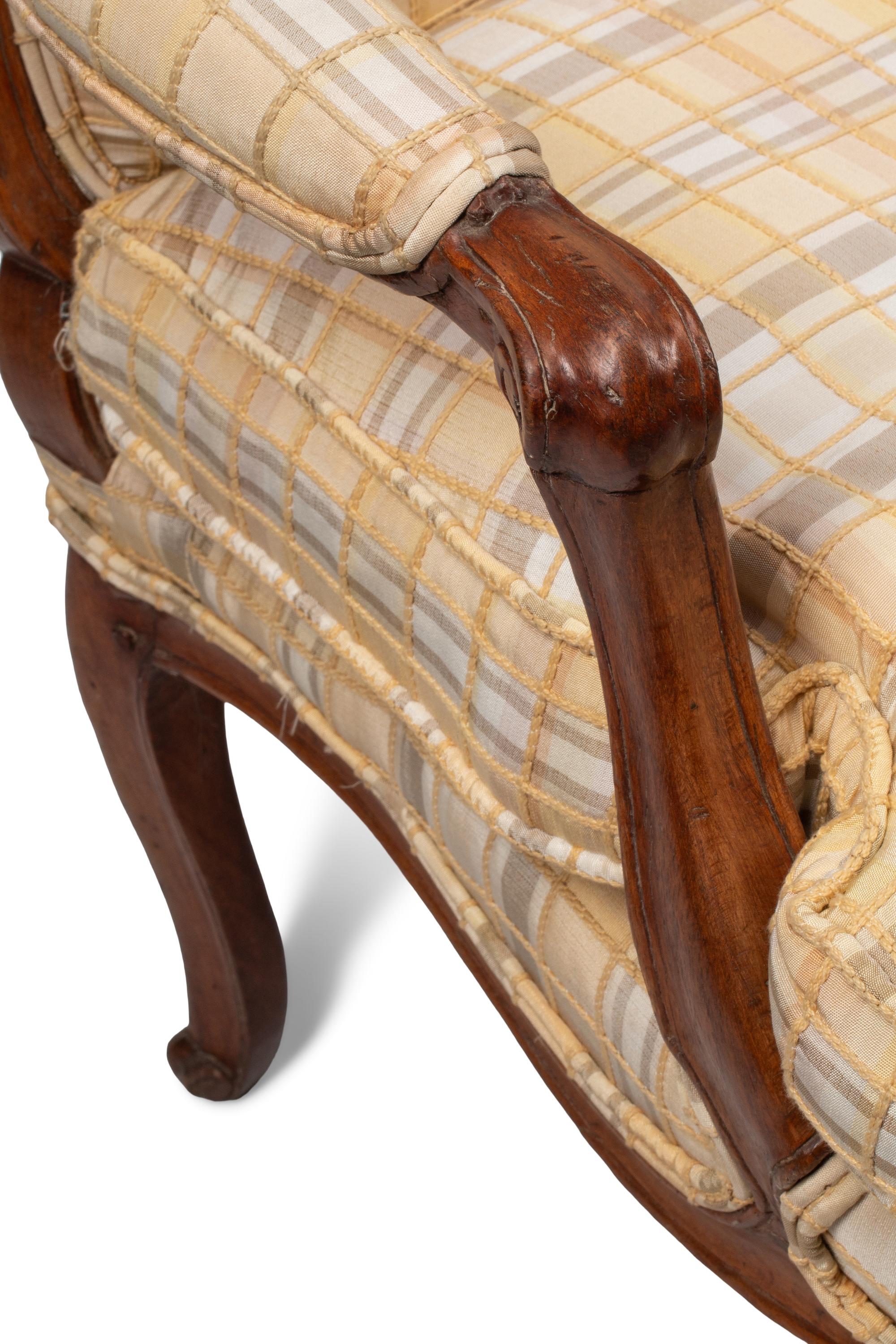A Pair of Louis XV Provincial Walnut Fauteuils