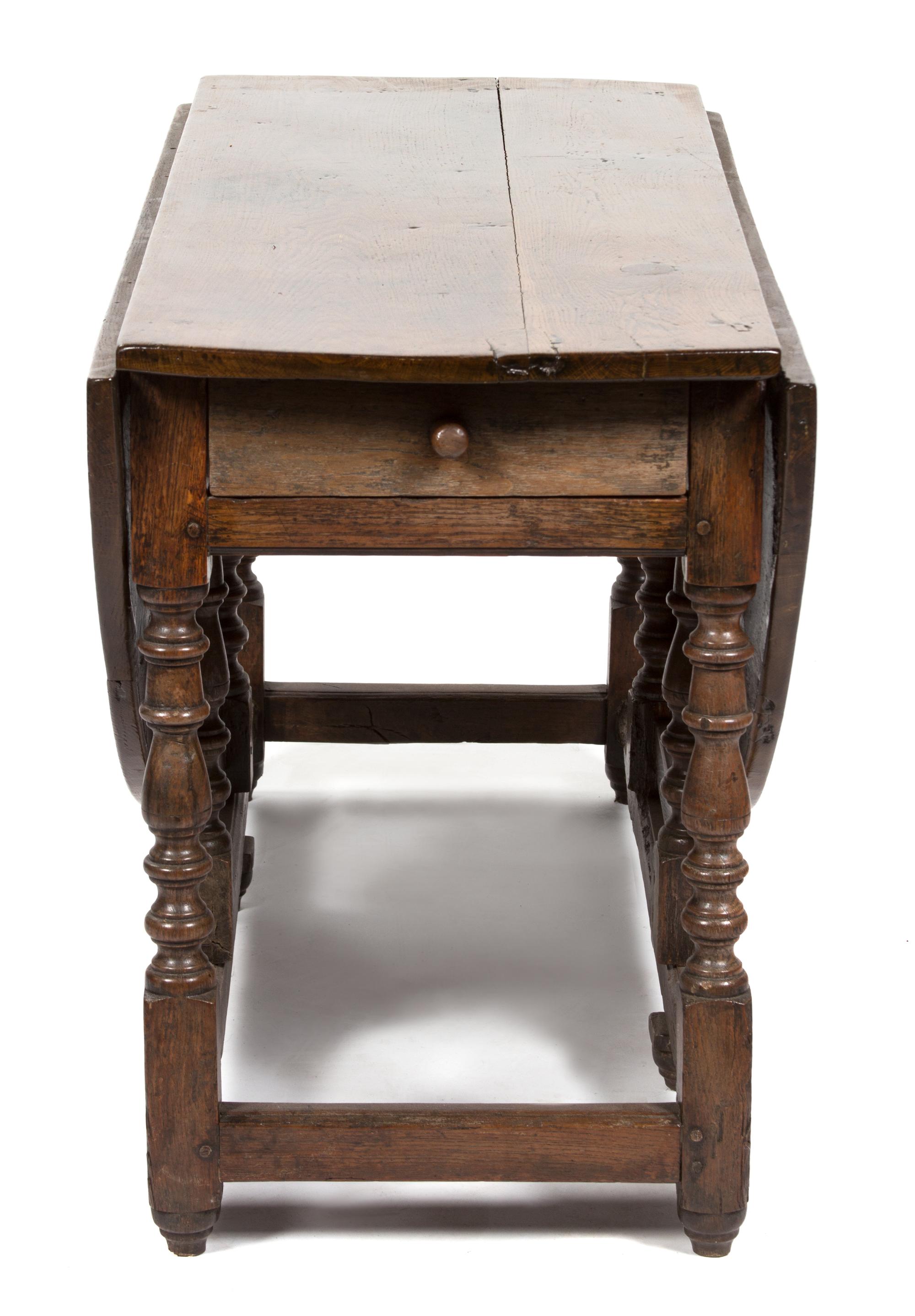 An English Oak Gate Leg Table Height 29 1/2 x width 52 x depth 21 inches (closed).