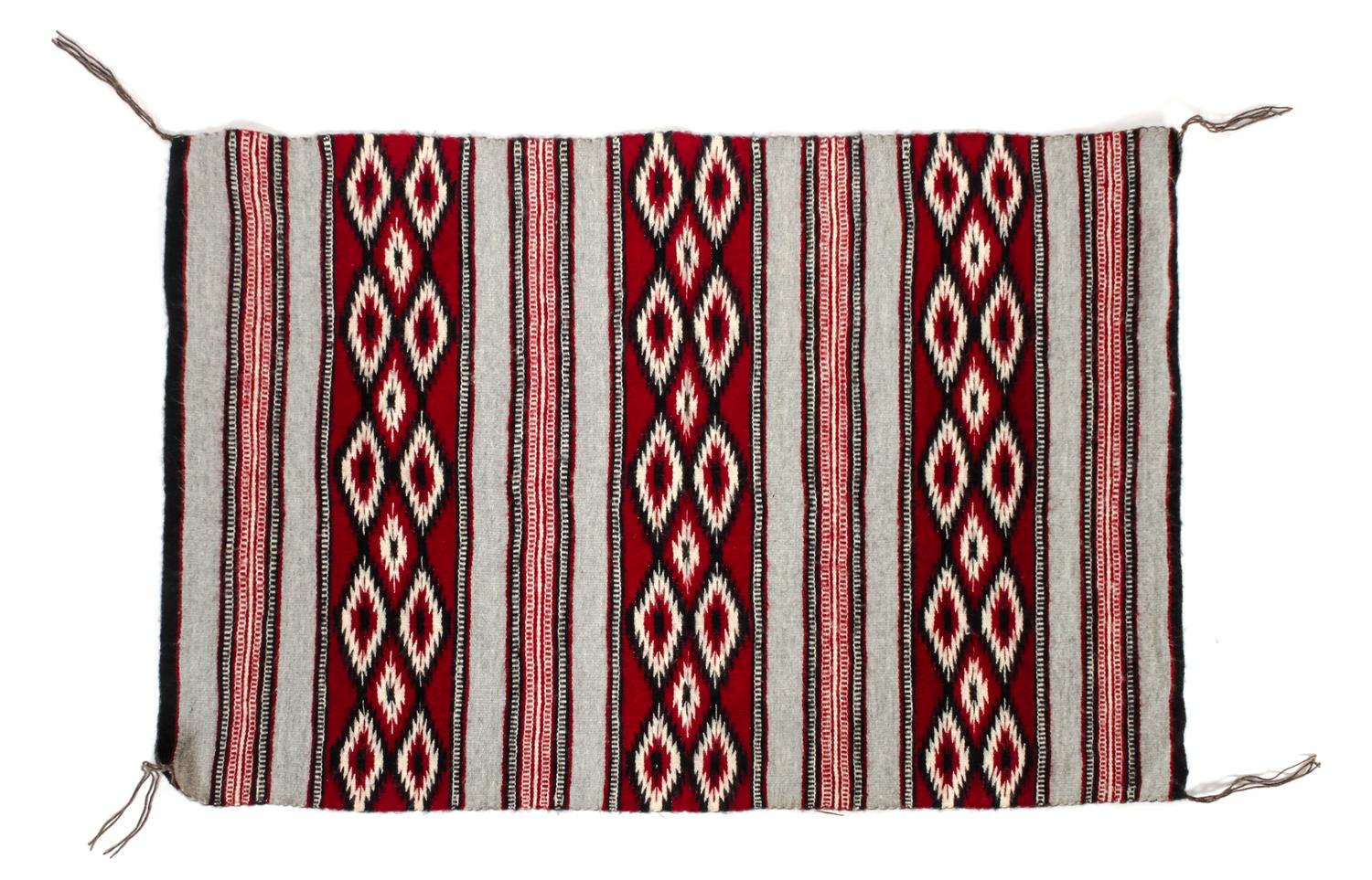 A Navajo Yei Rug First: 33 x 21 inches.