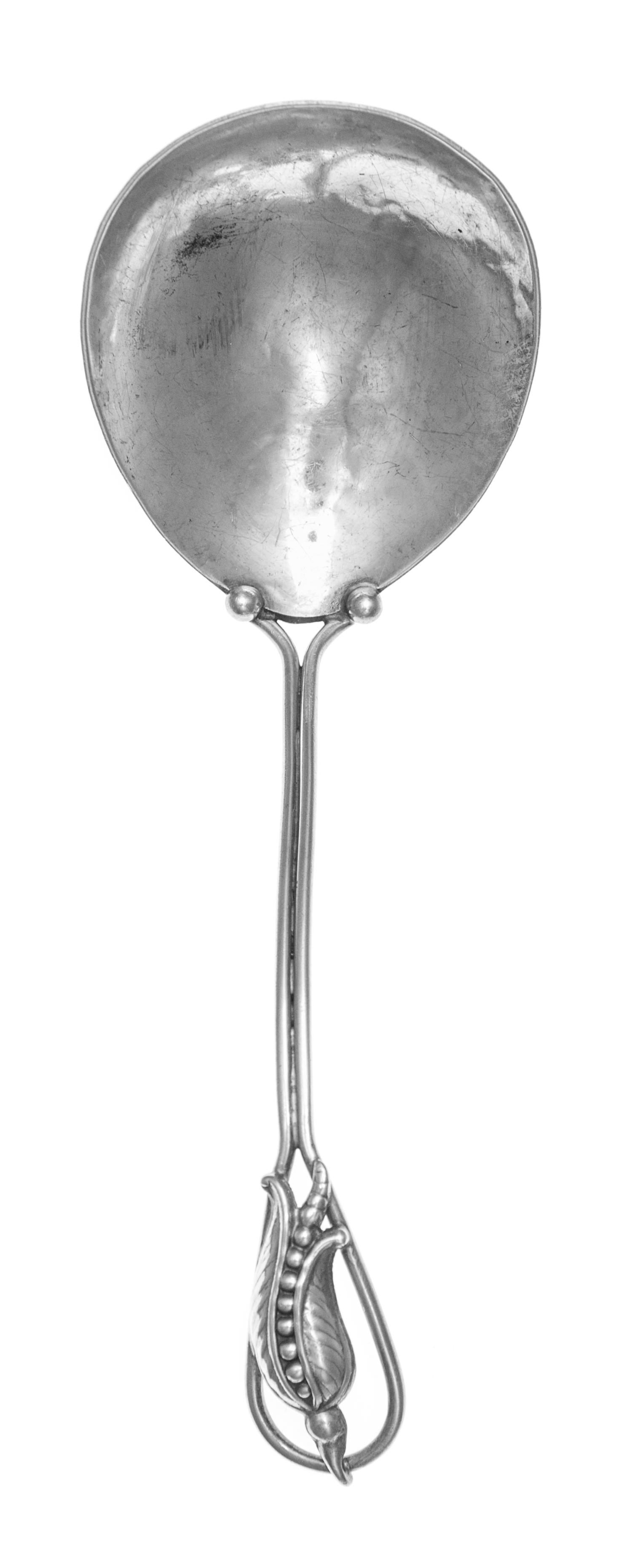 A Canadian Silver Berry Spoon, Carl Poul Pedersen, Montreal, having a wire handle decorated with a floral blossom, the bowl with spot-h
