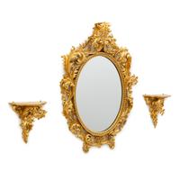 An Italian Rococo Style Carved Giltwood Oval Mirror and a Pair of Wall Brackets