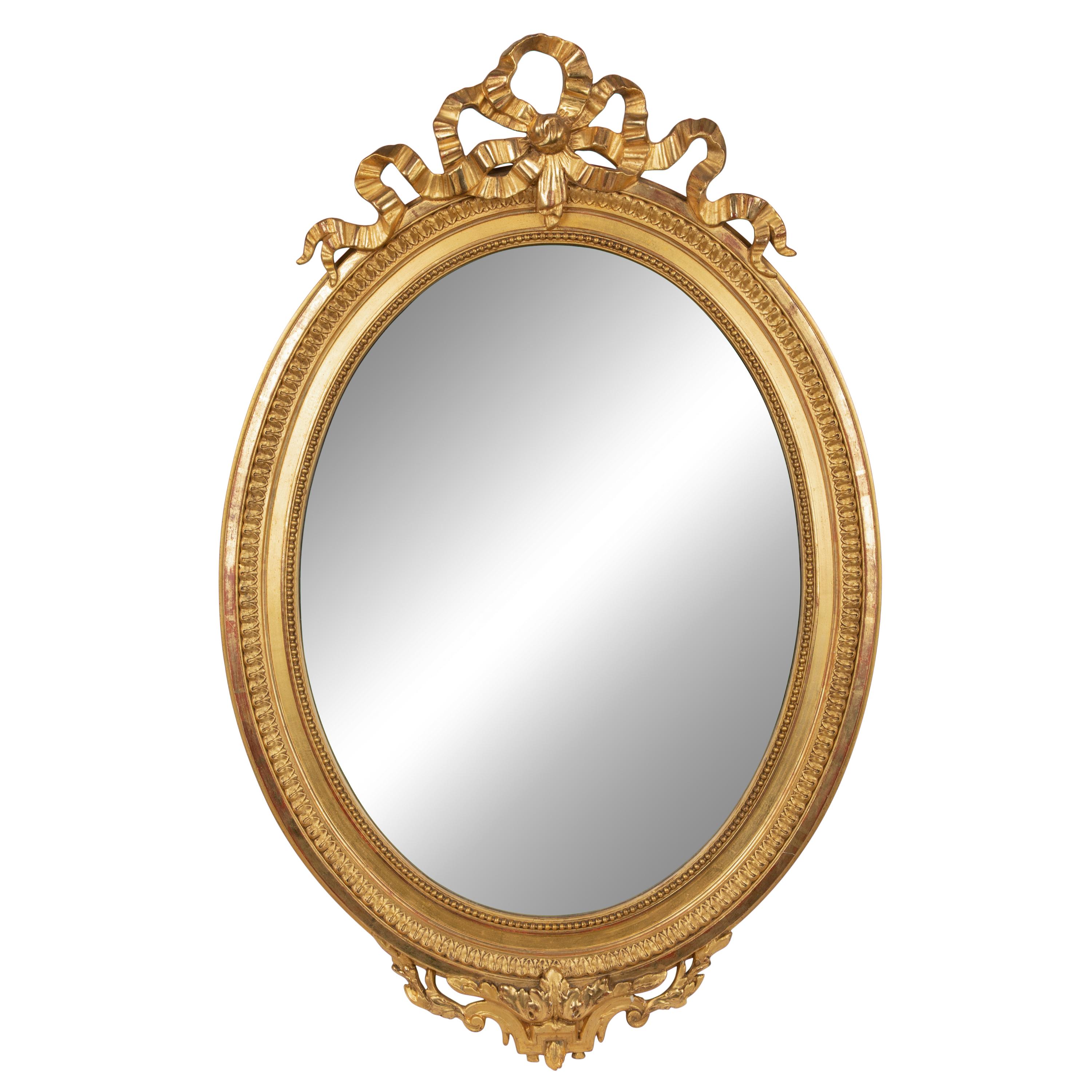 A Louis XV Style Giltwood Framed Oval Mirror