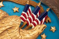 A Carved and Painted Eagle and a Carved, Painted and Parcel Gilt Eagle Plaque