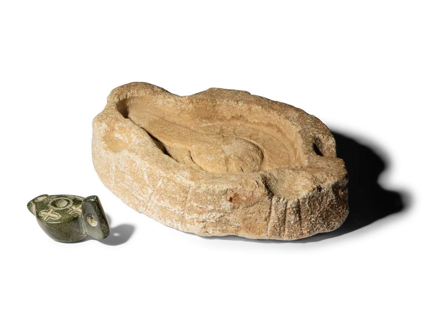 A Byzantine Black Stone Lamp with Crosses and a Byzantine Limestone Lamp Mold with a Chi Rho
