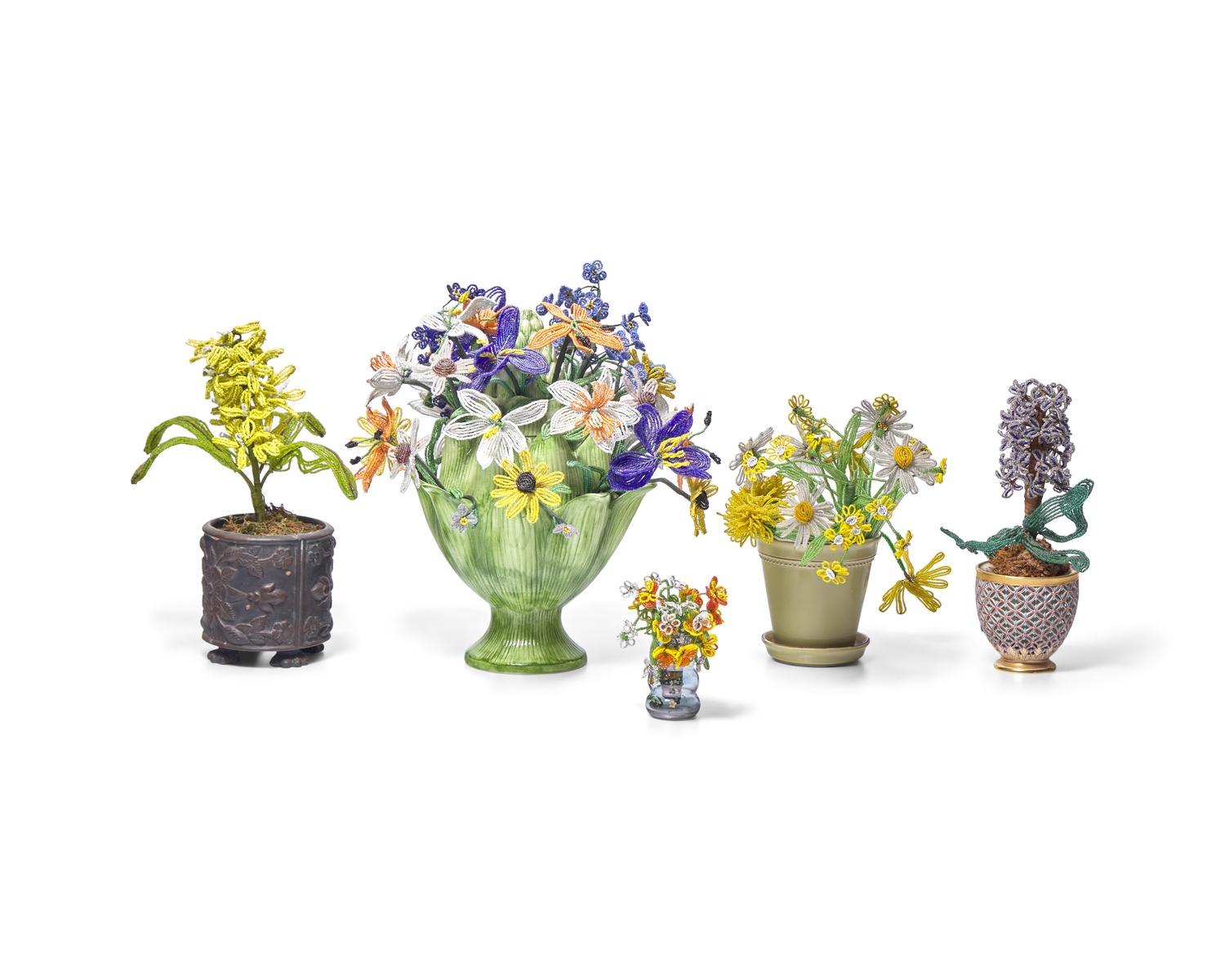 A Collection of Twenty-One French Beaded and Glass Flower and Fruit Arrangements