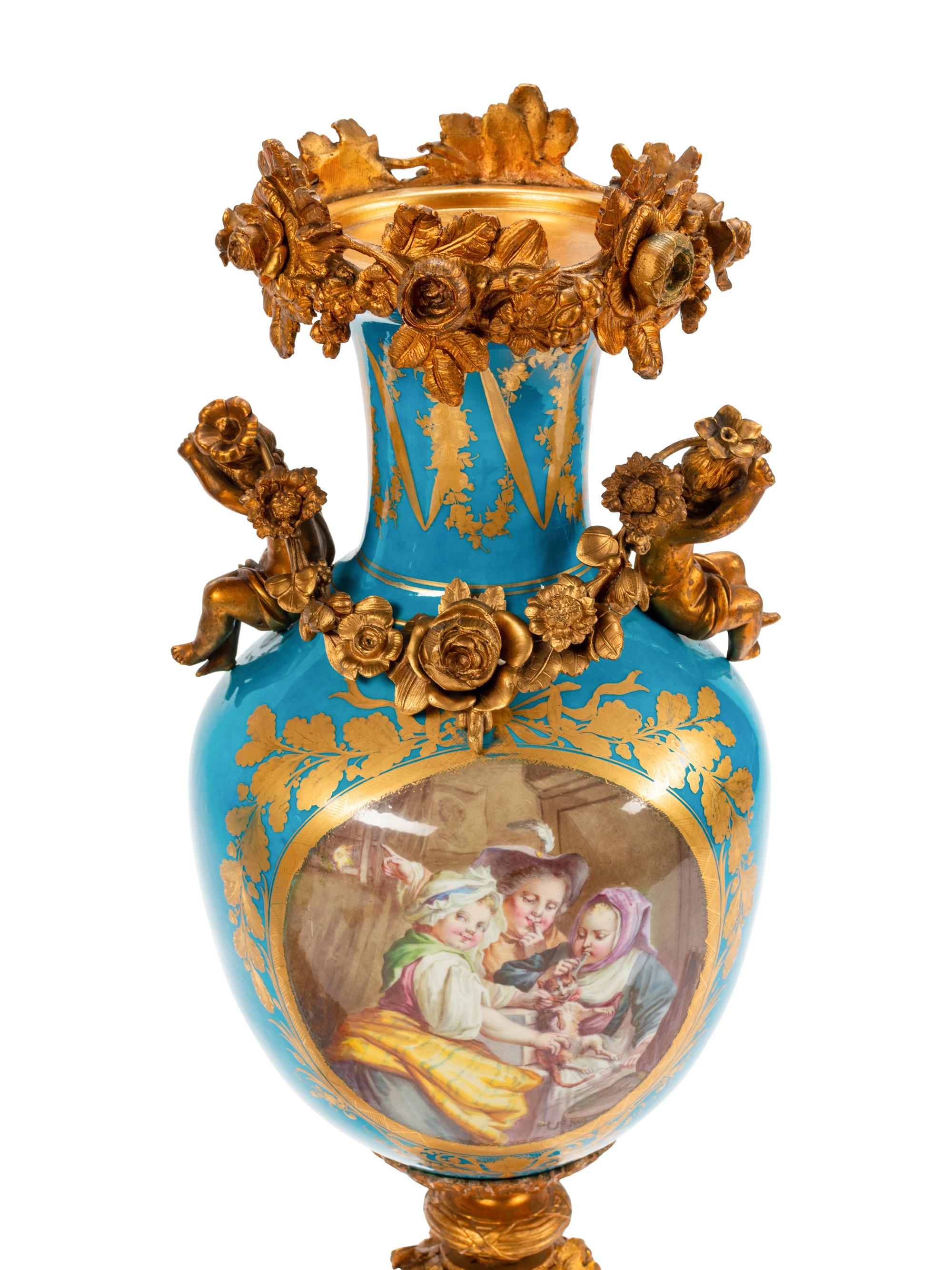 A Pair of Sèvres Style Gilt Bronze Mounted Porcelain Urns