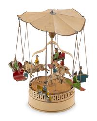 A German Painted Tin Swing Carousel Toy