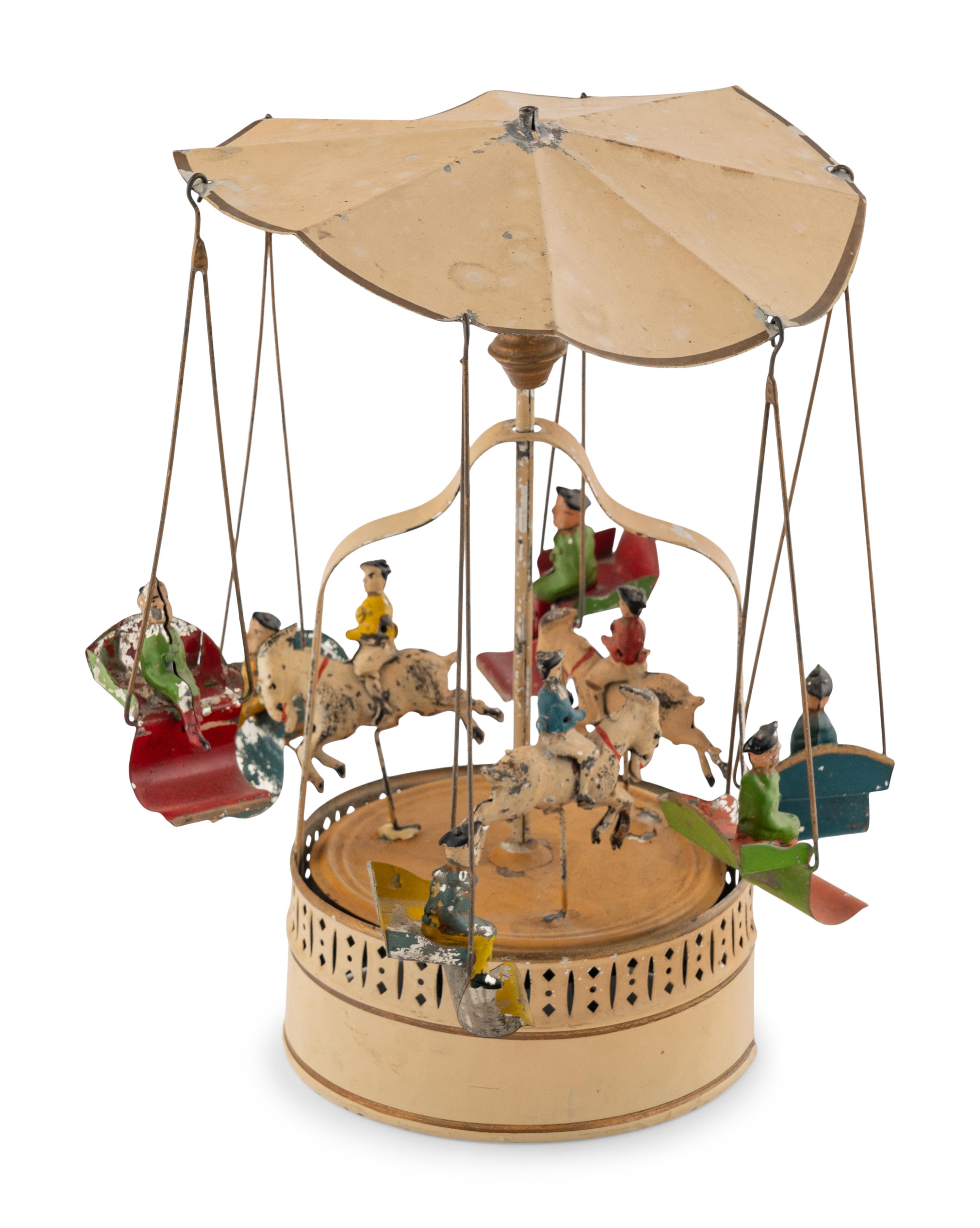 A German Painted Tin Swing Carousel Toy