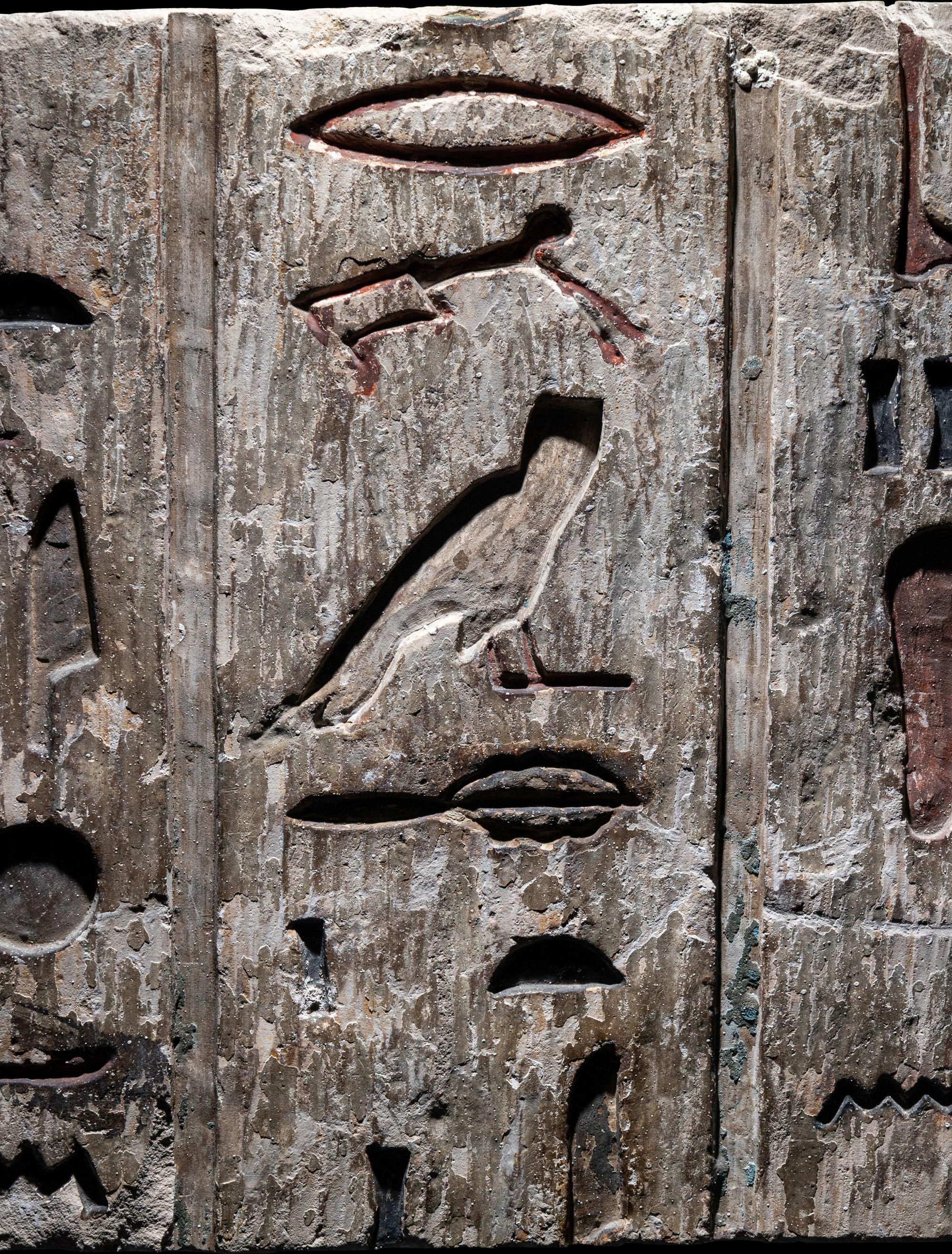 An Egyptian Polychrome Limestone Relief Fragment