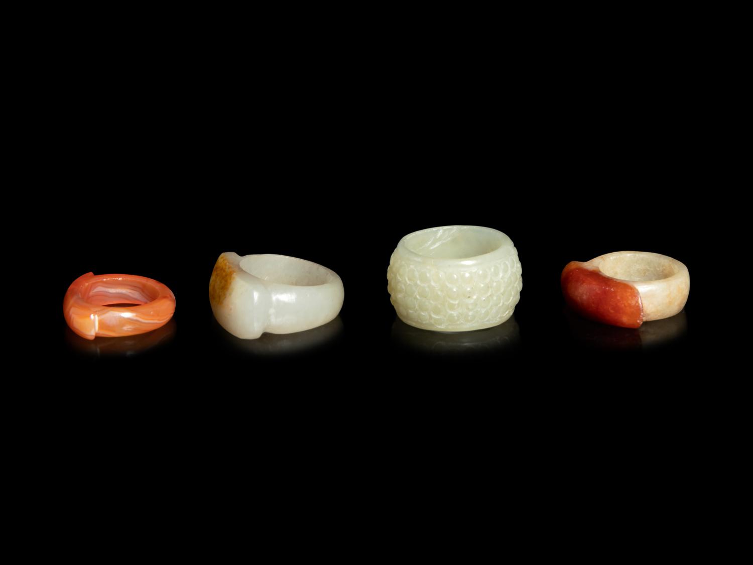 Four Chinese Jade and Hardstone Archer's Rings