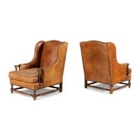A Pair of Louis XIII Style Oak and Leather Wingback Armchairs