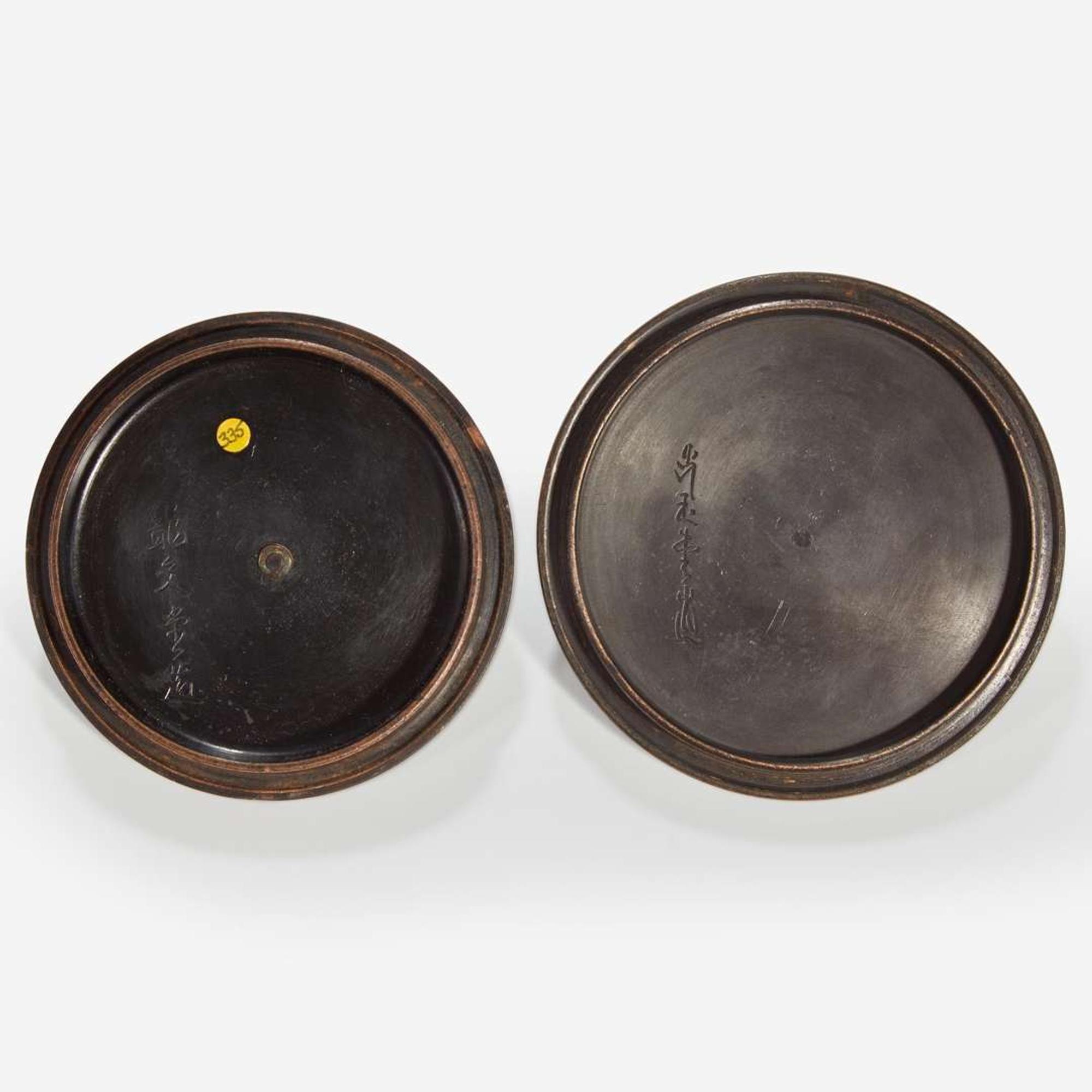 Two Japanese iron tetsubin with patinated bronze covers