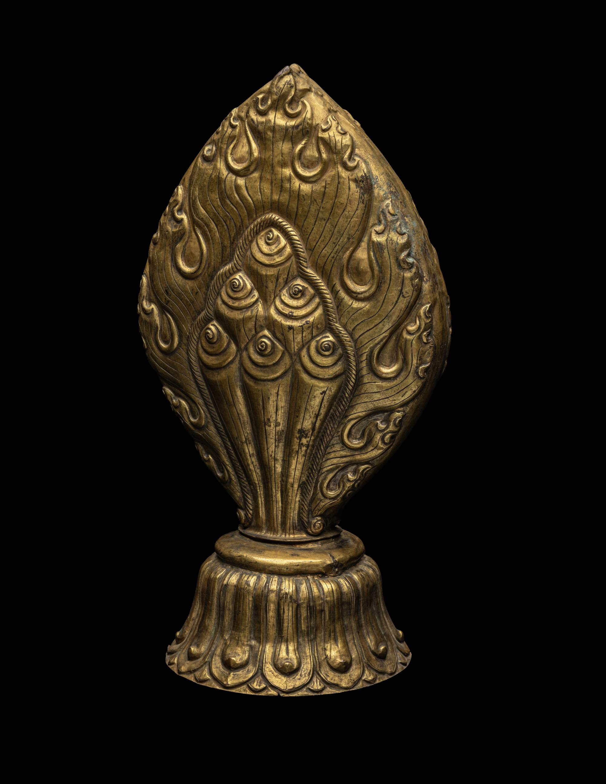 A Nepalese Repoussé Gilt Bronze Flaming Jewel Altar Piece