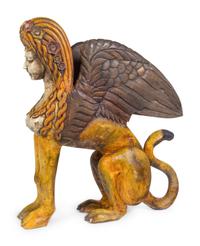 A Large Carved and Polychrome Decorated Wood Sphinx