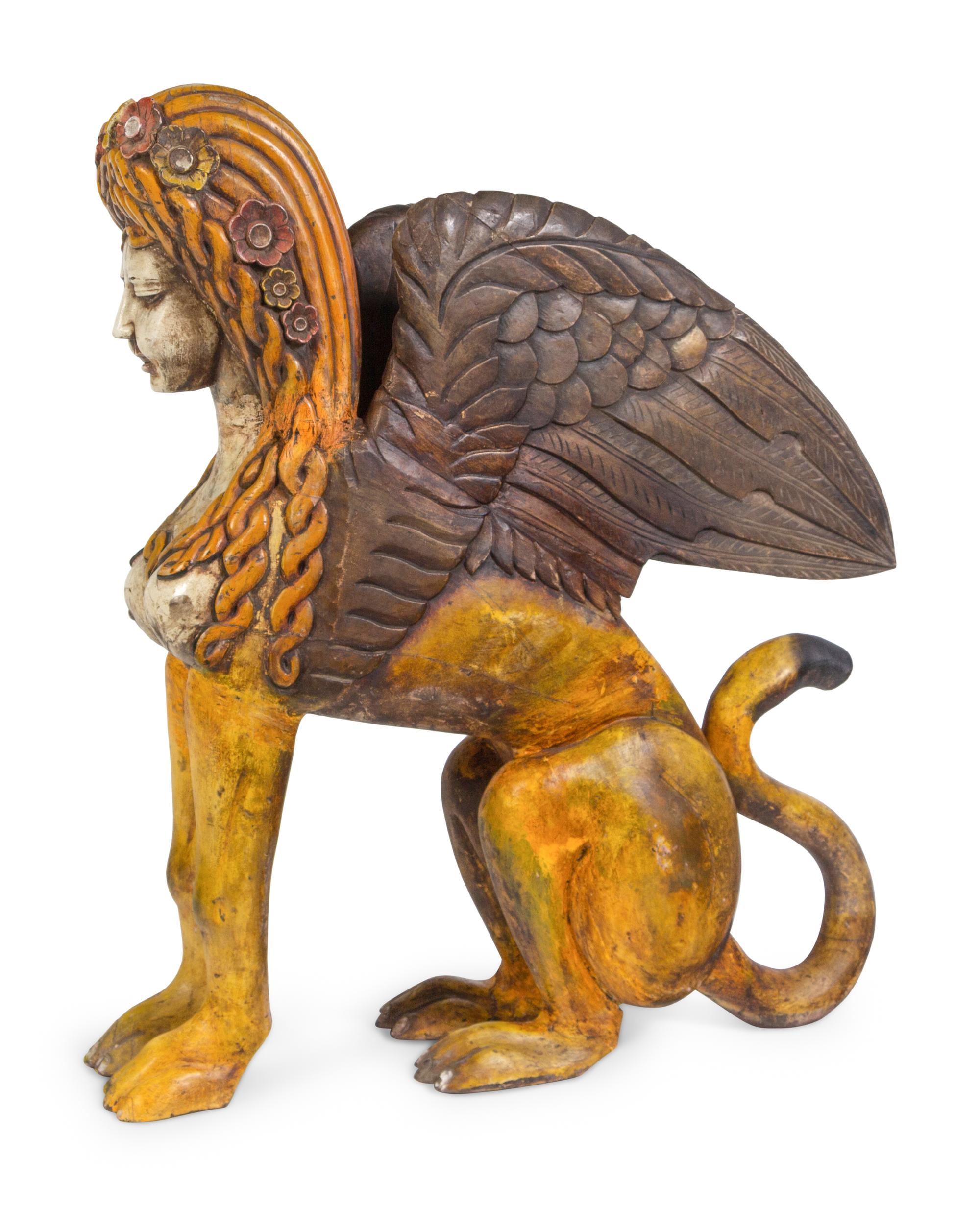 A Large Carved and Polychrome Decorated Wood Sphinx