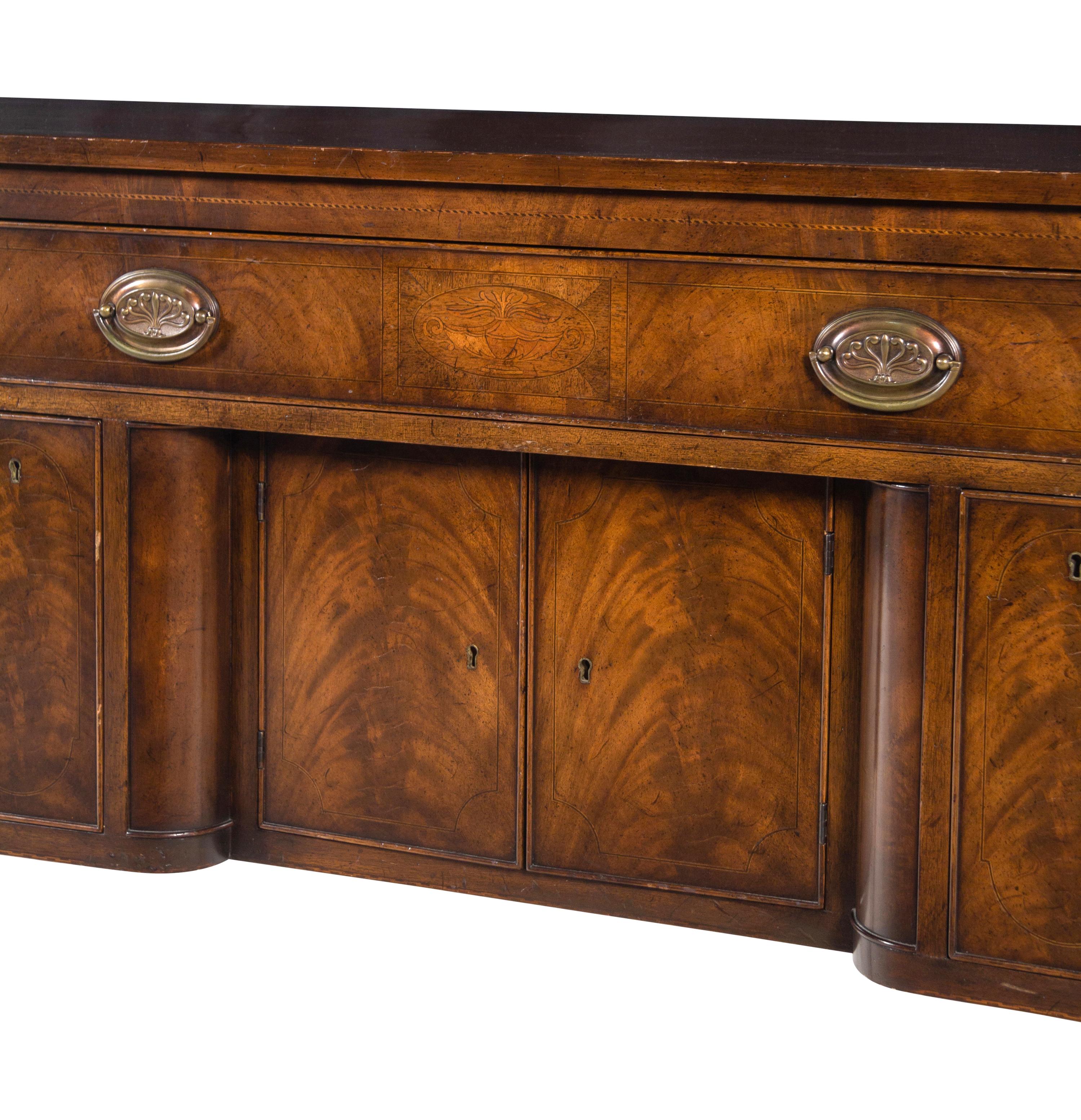 A Regency Style Mahogany Sideboard with Silk Drape on a Brass Gallery