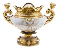 A French Gilt Metal Mounted Ceramic Urn Height 16 1/2 x width over handes 21 inches.