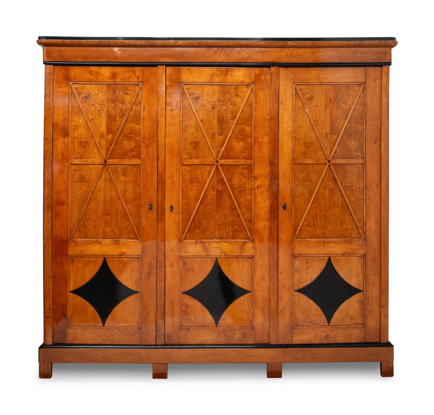 A Biedermeier Part-Ebonized Maple Three-Door Armoire