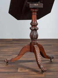 A Late Federal Carved and Figured Mahogany Octagonal Tilt-Top Candlestand