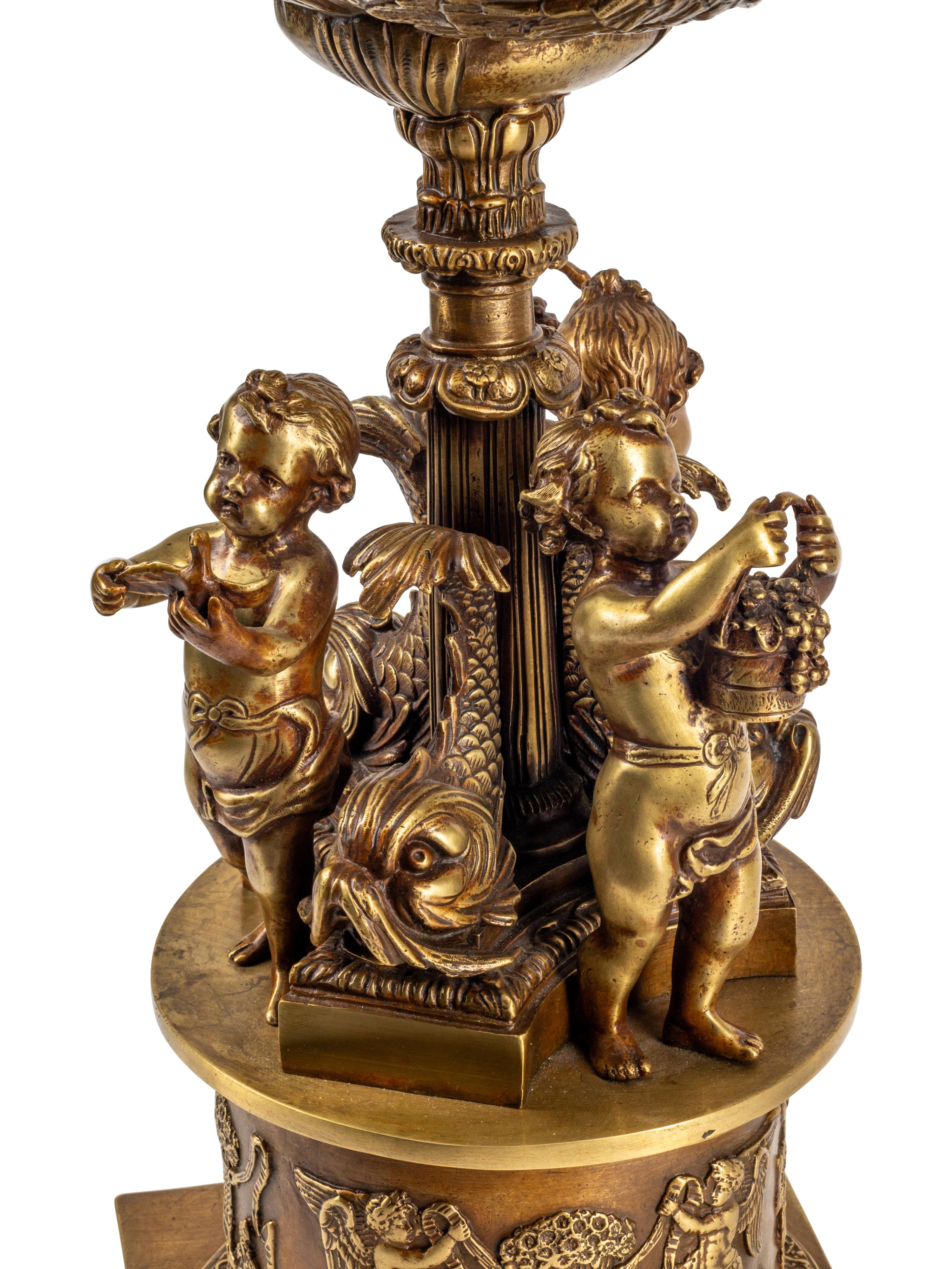 An Empire Style Gilt Bronze and Cut Glass Figural Centerpiece