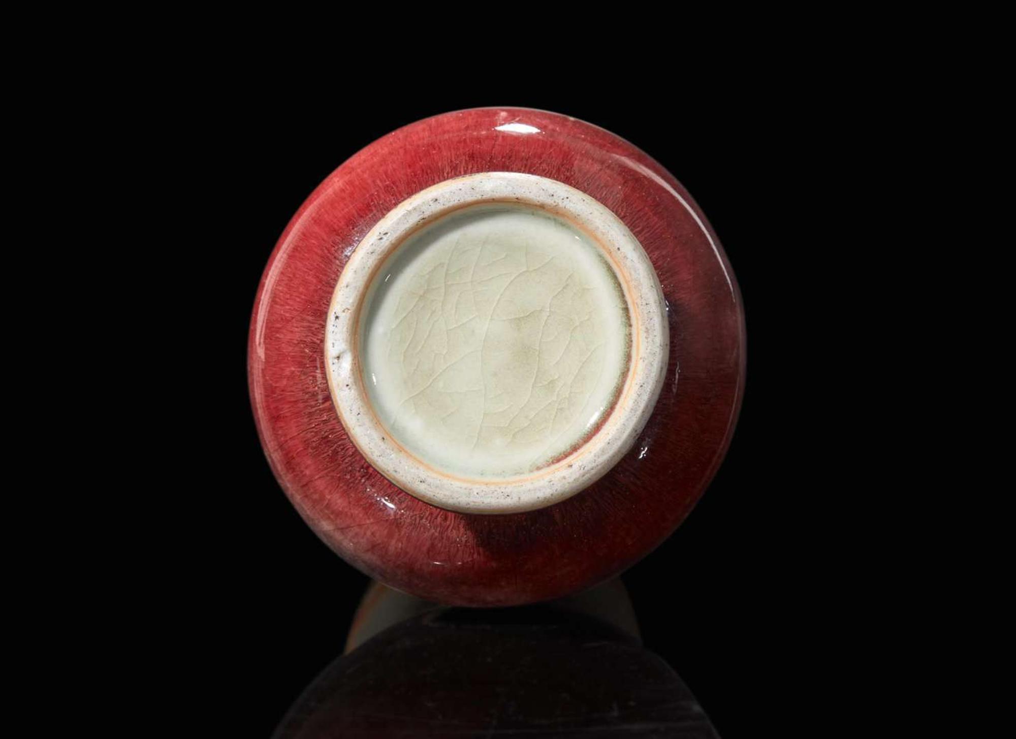 A Chinese copper-red glazed porcelain vase, Qing dynasty 銅紅釉觶瓶 清